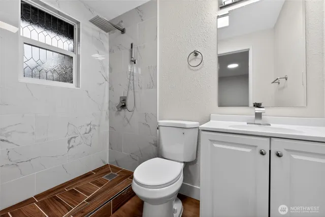 a bathroom with a sink toilet and shower