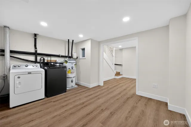 a view of a kitchen with a stove wooden cabinets and wooden floor