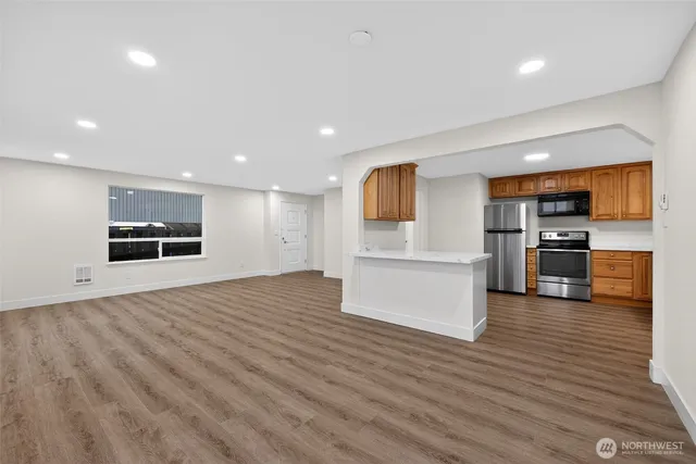 a view of kitchen with microwave and cabinets