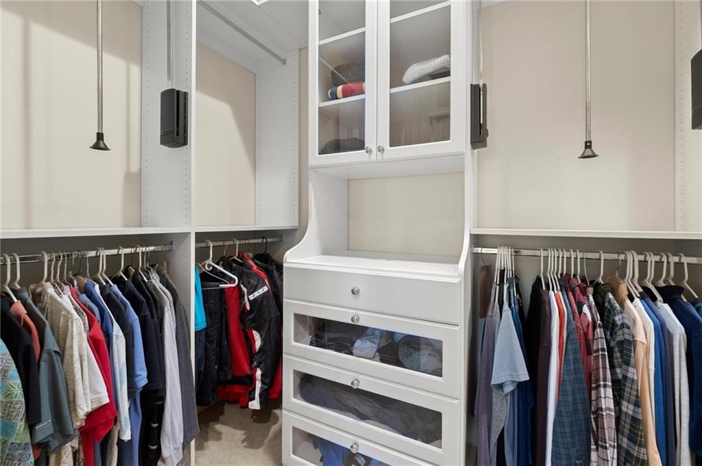322 Edwards Brook Lane Canton, GA 30115 - Photo 47 of 99 a view of walk in closet with clothes and shoes