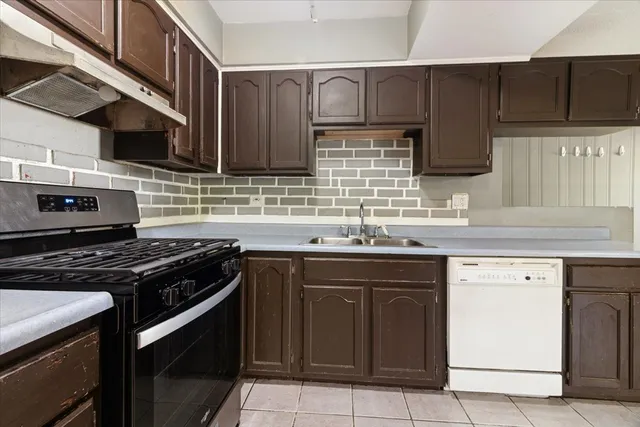 a kitchen with stainless steel appliances granite countertop a sink stove and cabinets