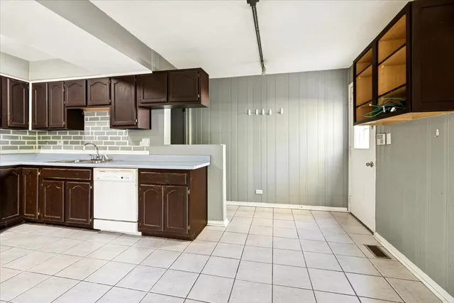 a kitchen with stainless steel appliances a sink and a refrigerator