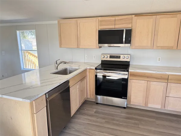 a kitchen with a sink stove and microwave