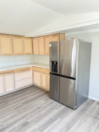 a kitchen with kitchen island a sink a stove and refrigerator