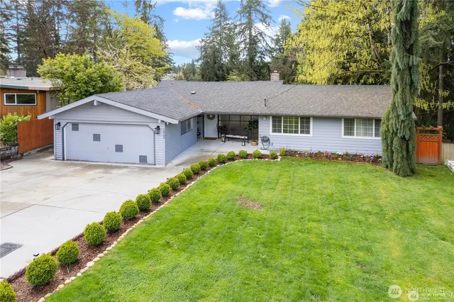 a view of a house with a big yard and potted plants
