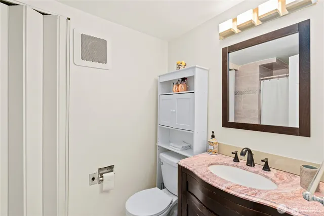 a bathroom with a sink toilet and mirror