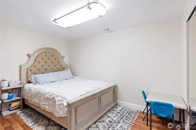 a bedroom with a bed and a chair in it