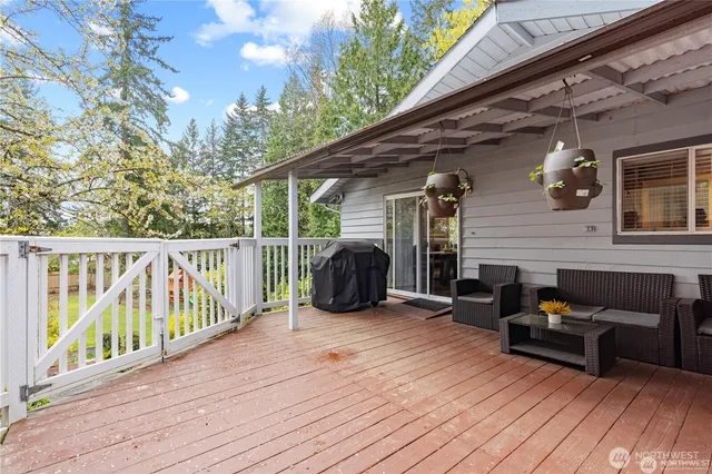 a view of a deck with furniture and wooden floor