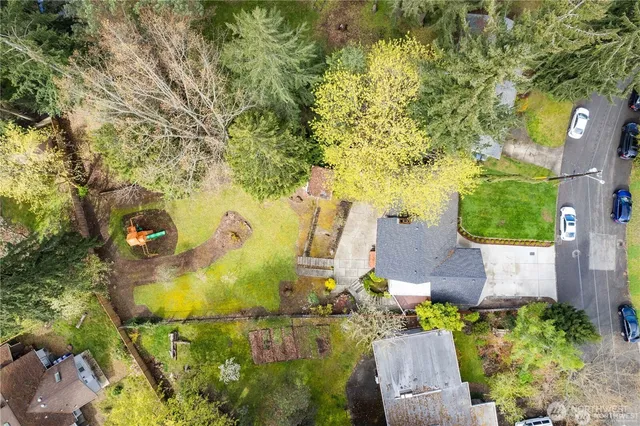 an aerial view of a residential houses with yard