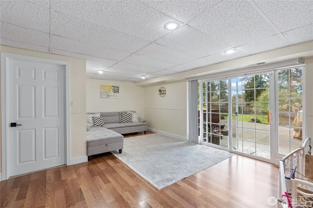a spacious bedroom with a bed and glass door
