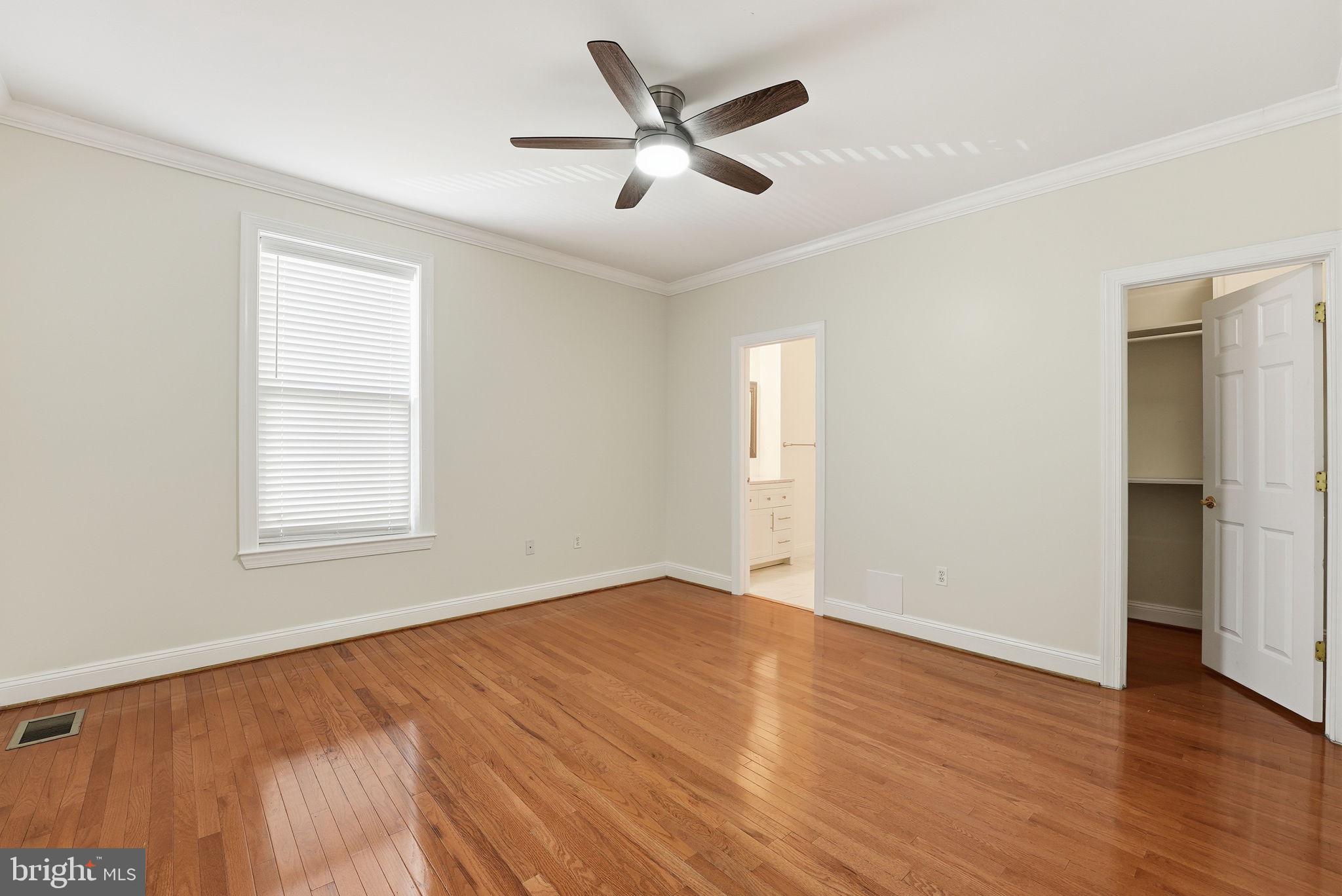 1229 12th Street Northwest, Unit 109 Washington, DC 20005 - Photo 12 of 23 an empty room with wooden floor and windows