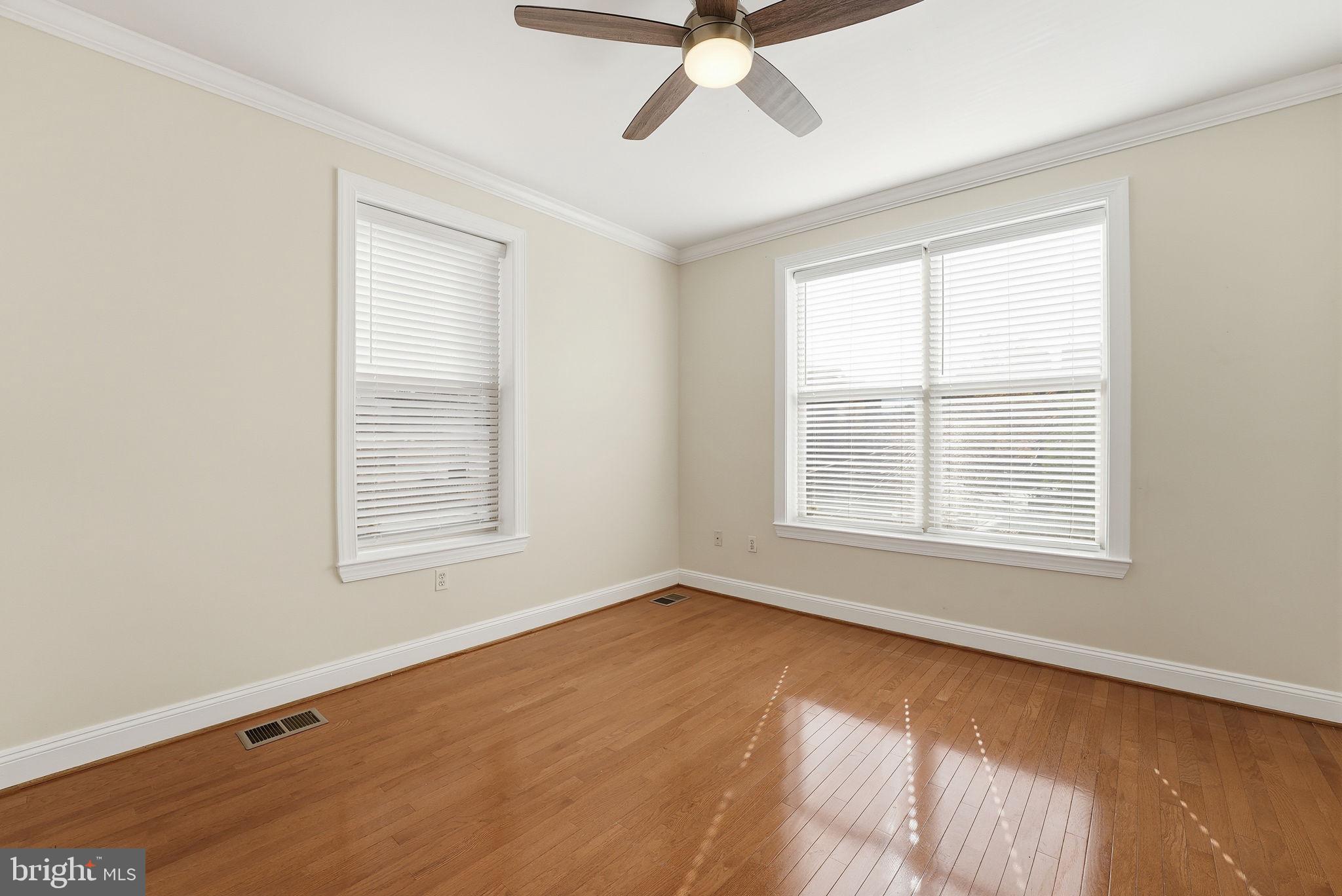 1229 12th Street Northwest, Unit 109 Washington, DC 20005 - Photo 19 of 23 a view of an empty room with a window and wooden floor