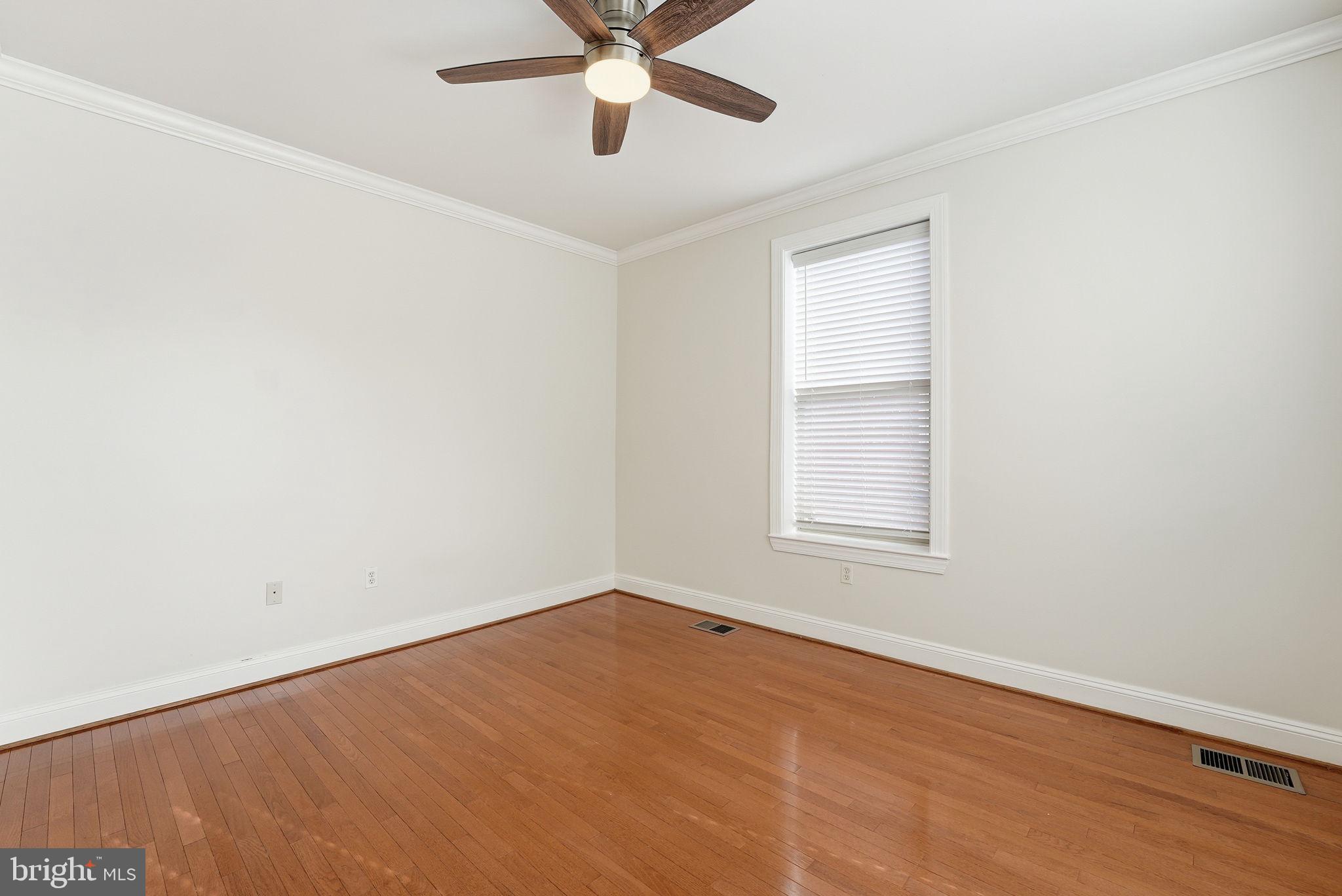1229 12th Street Northwest, Unit 109 Washington, DC 20005 - Photo 21 of 23 an empty room with a window and a fan