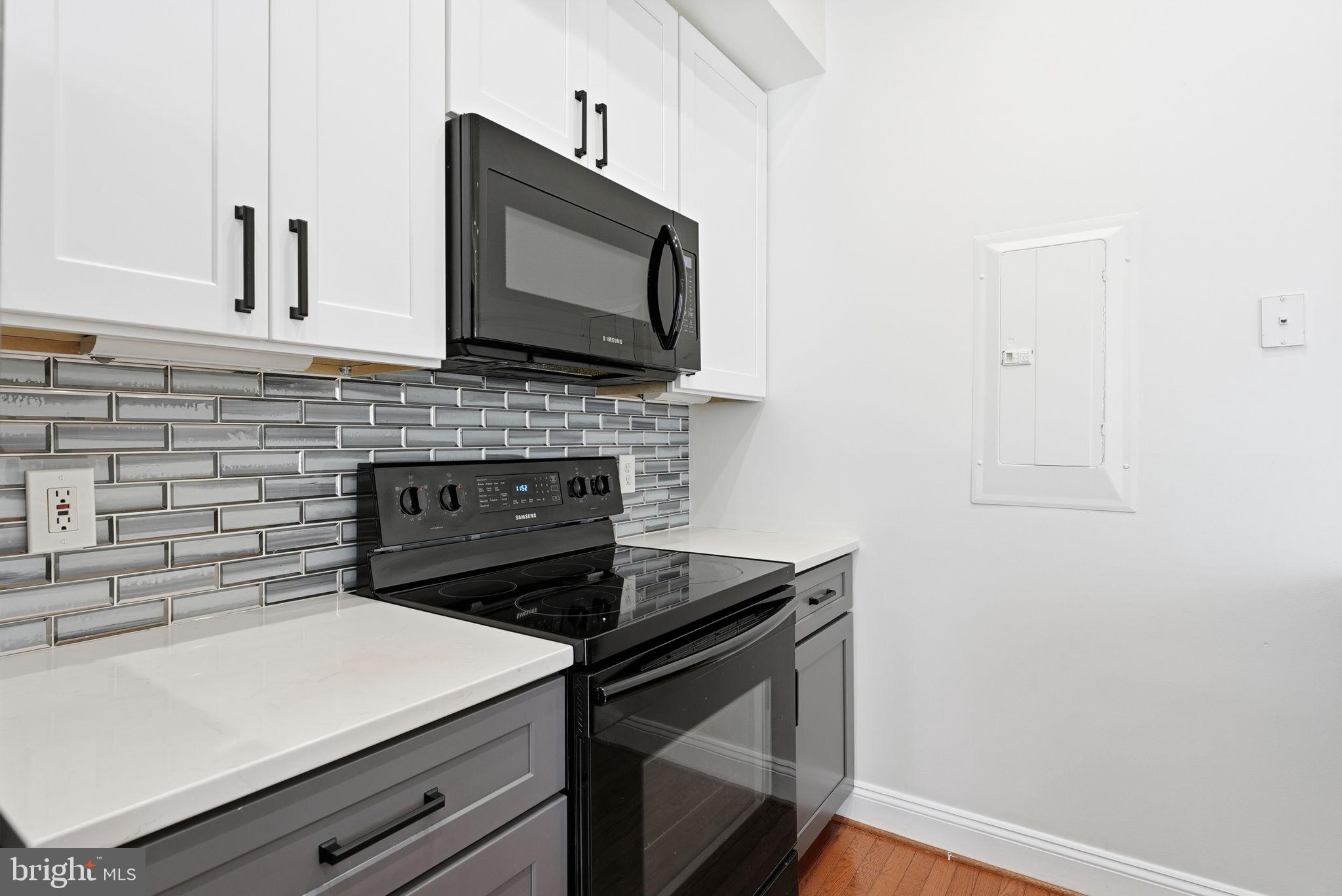 1229 12th Street Northwest, Unit 109 Washington, DC 20005 - Photo 5 of 23 a kitchen with a stove microwave and sink
