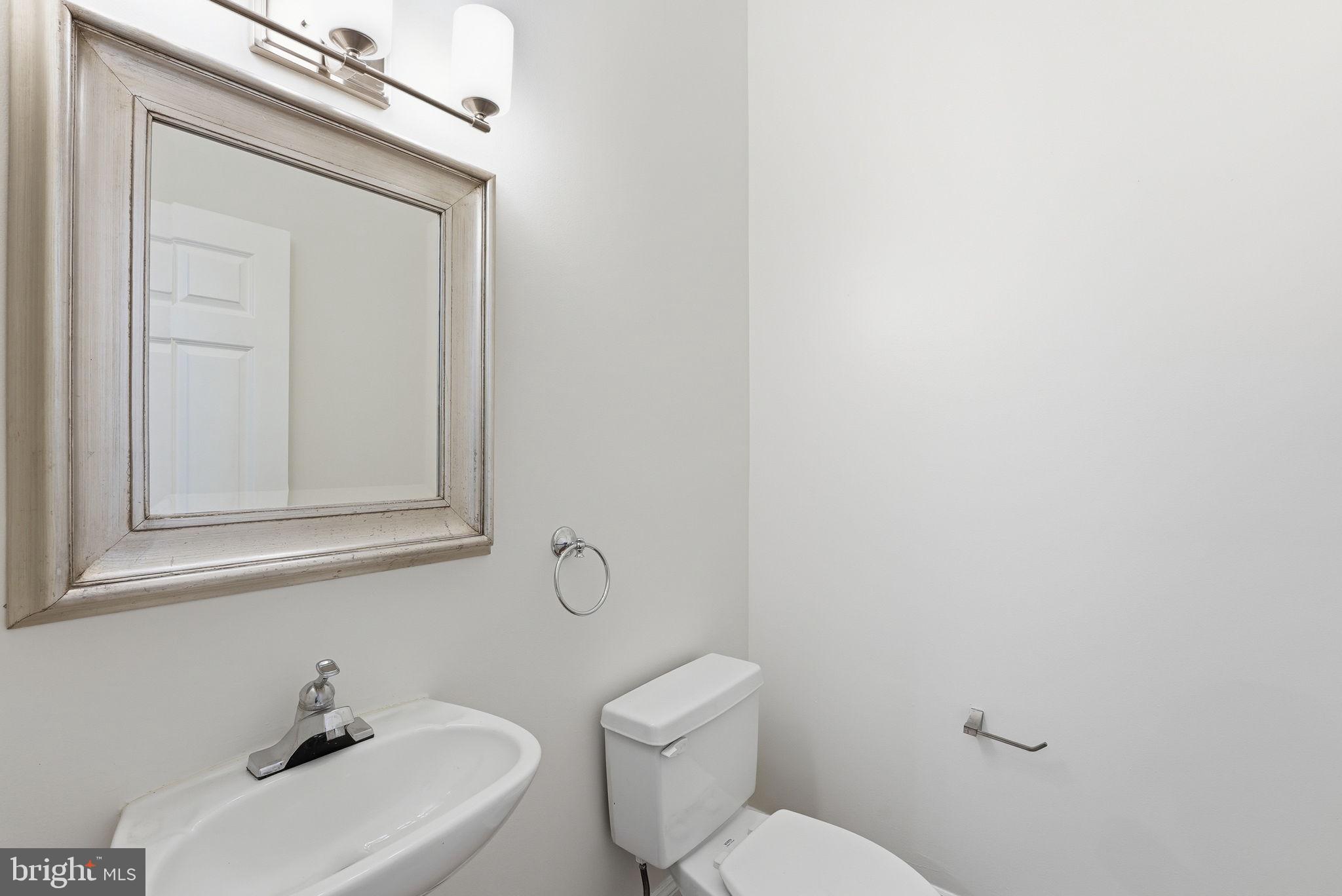 1229 12th Street Northwest, Unit 109 Washington, DC 20005 - Photo 10 of 23 a white toilet sitting next to a bathroom sink