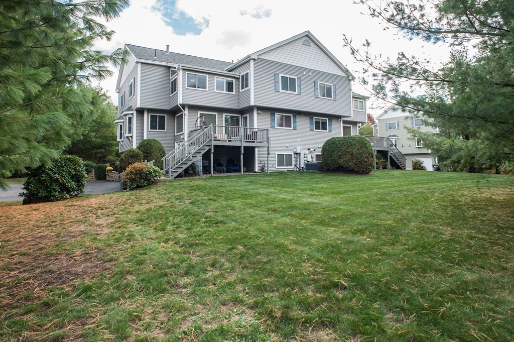 1501 Old Bridge Lane, Unit 1501 Bellingham, MA 02019 - Photo 1 of 42 a view of a house with a yard