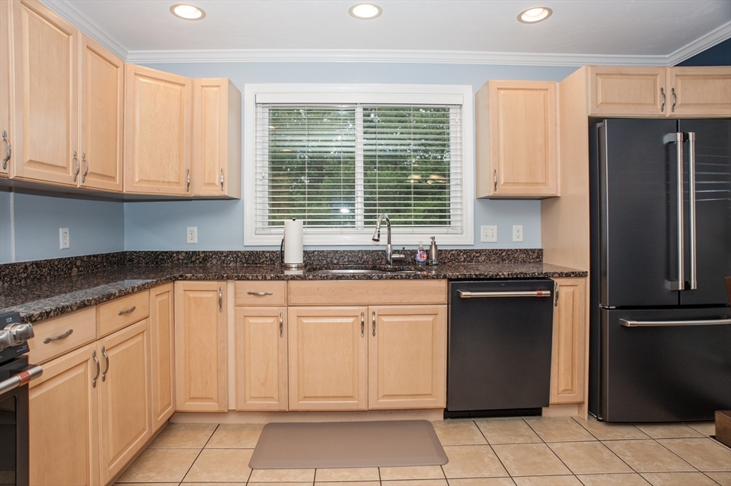 1501 Old Bridge Lane, Unit 1501 Bellingham, MA 02019 - Photo 13 of 42 a kitchen with granite countertop a refrigerator sink and cabinets