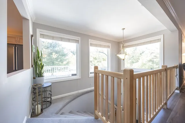 a view of a livingroom with wooden floor and furniture