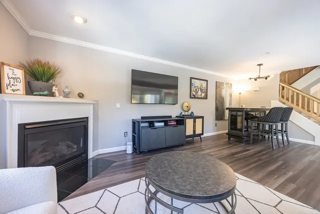 a view of staircase with lots of frames on wall and a window