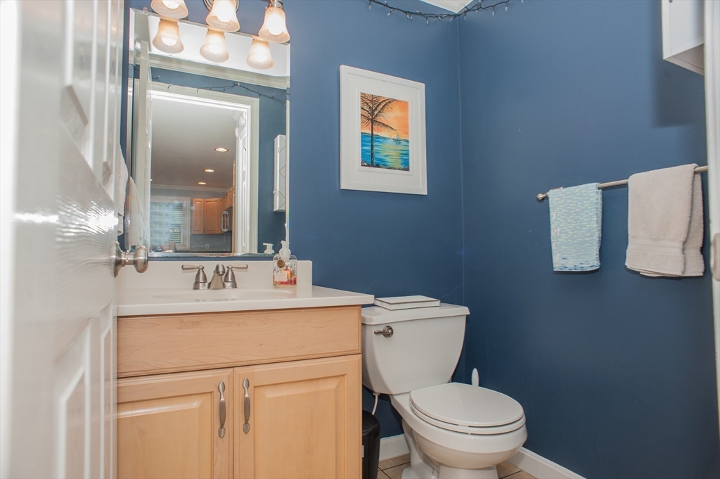 1501 Old Bridge Lane, Unit 1501 Bellingham, MA 02019 - Photo 16 of 42 a bathroom with a toilet sink and mirror