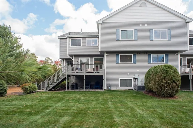a view of a house with a yard and sitting area