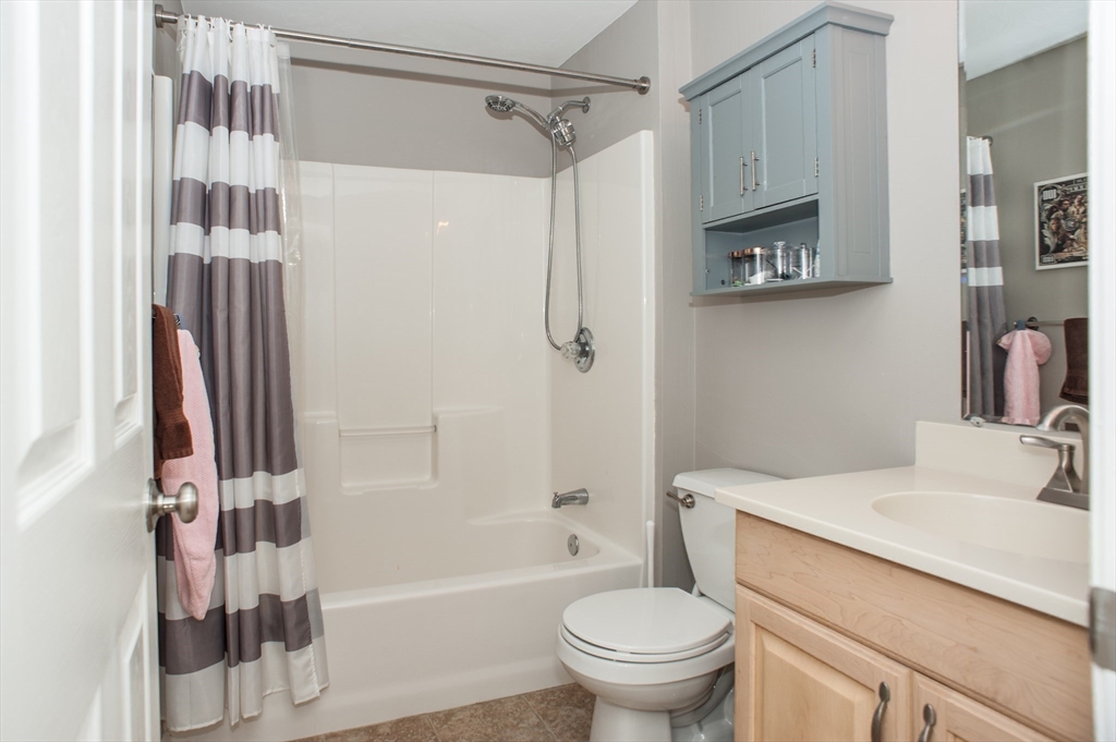 1501 Old Bridge Lane, Unit 1501 Bellingham, MA 02019 - Photo 22 of 42 a bathroom with a sink toilet and shower
