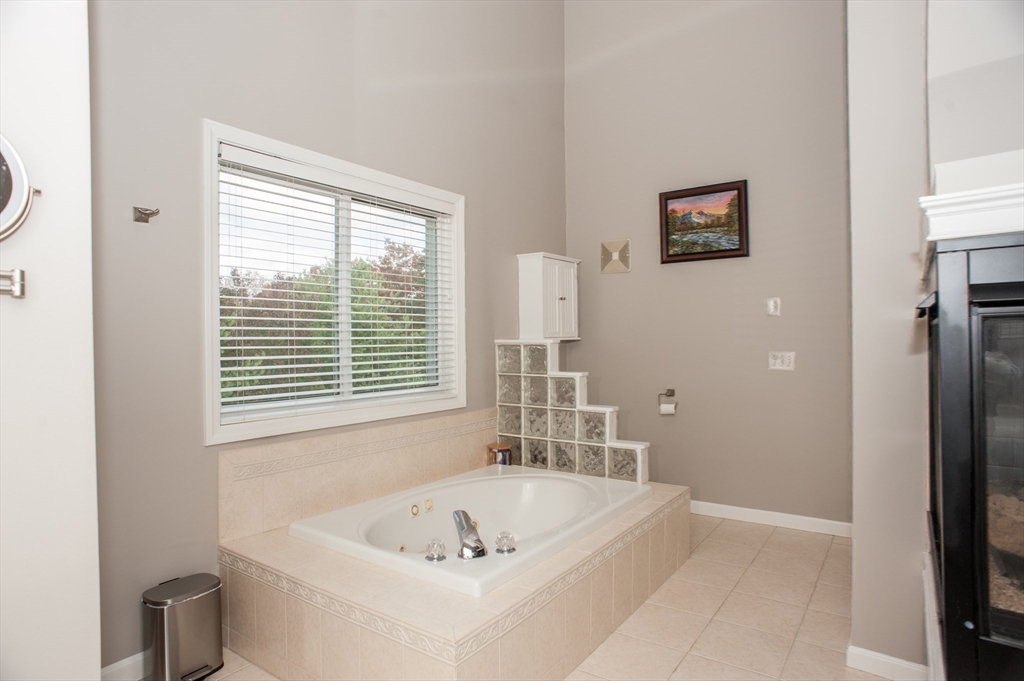 1501 Old Bridge Lane, Unit 1501 Bellingham, MA 02019 - Photo 29 of 42 a bathroom with a bathtub and a sink
