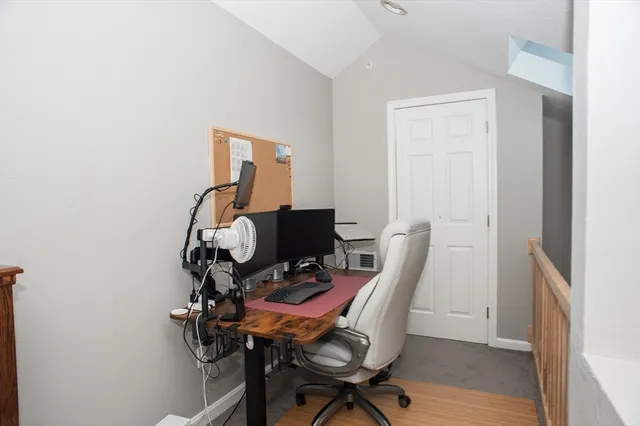 a view of a workspace with furniture and wooden floor