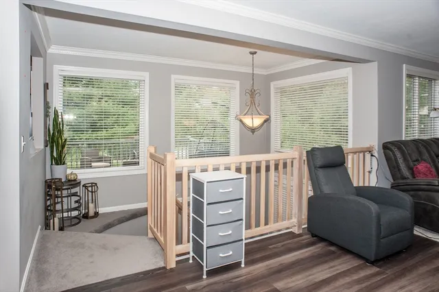 a living room with furniture and large windows