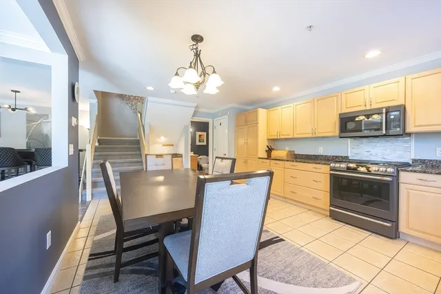 a view of a dining room with furniture and chandelier