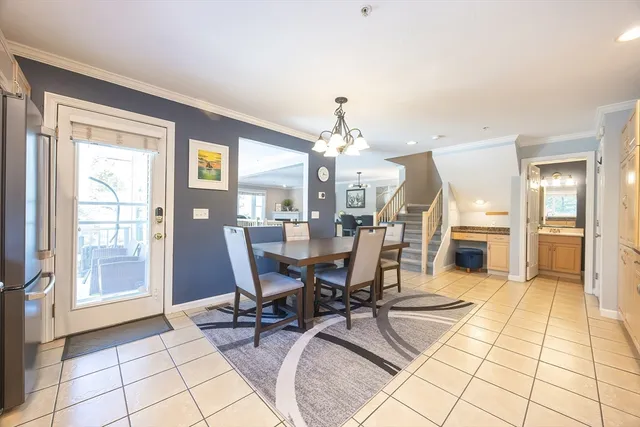 a large kitchen with a table and chairs