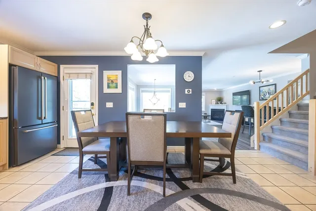 a kitchen with stainless steel appliances granite countertop a sink a stove a dining table and chairs