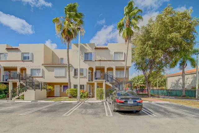 a view of a street that has a car parked on the road