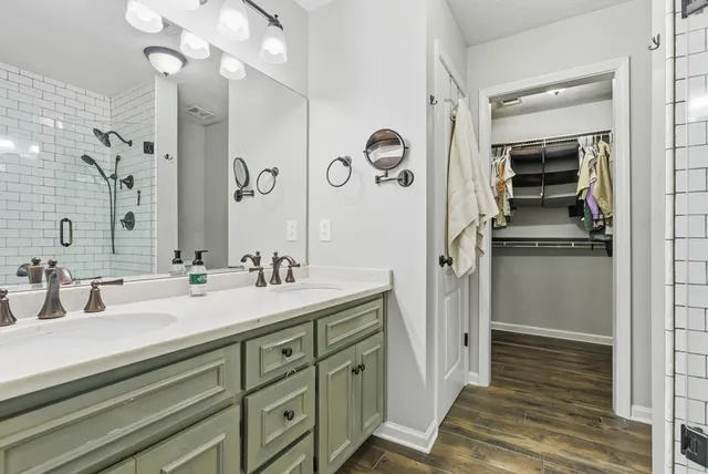 a bathroom with a sink a mirror and a shower