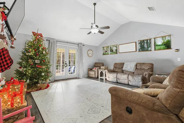a living room with furniture and a christmas tree