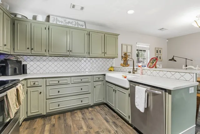 a kitchen with granite countertop a sink and cabinets