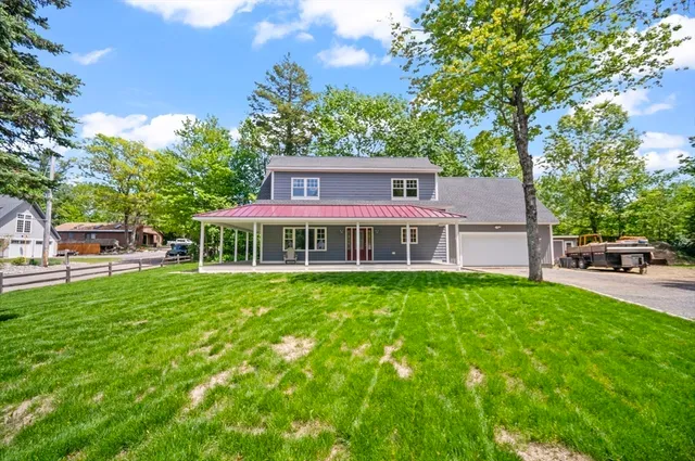 a view of a house with a backyard