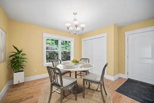a view of a dining room with furniture and chandelier