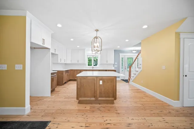 a large kitchen with a sink a counter top space and stainless steel appliances