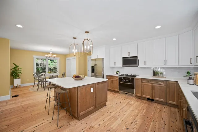 a kitchen with stainless steel appliances granite countertop a stove oven and a sink with cabinets