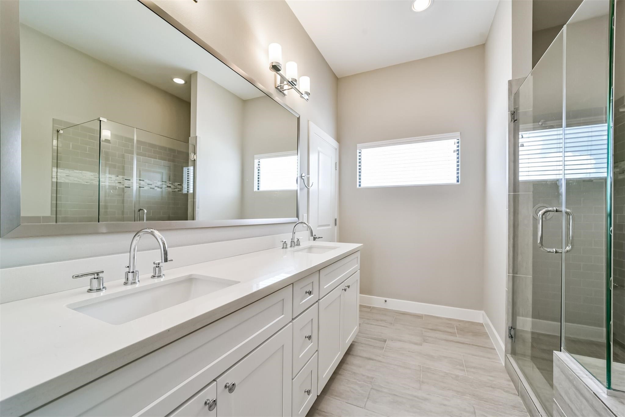 10806 Warwana Road, Unit C Houston, TX 77043 - Photo 6 of 9 a spacious bathroom with a double vanity sink mirror and next to a window