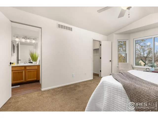 a bedroom with a bed and a view of kitchen