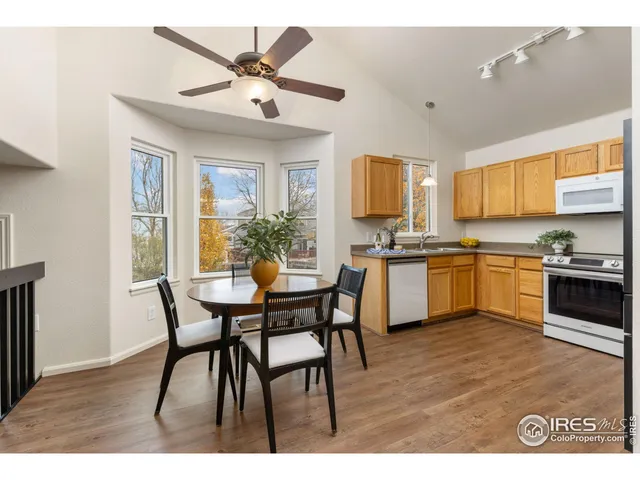 a kitchen with a table chairs microwave and cabinets