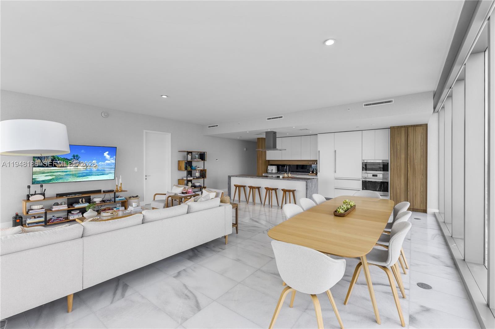 700 Northeast 26th Terrace, Unit 4701 Miami, FL 33137 - Photo 13 of 33 a kitchen with stainless steel appliances kitchen island granite countertop a sink and cabinets