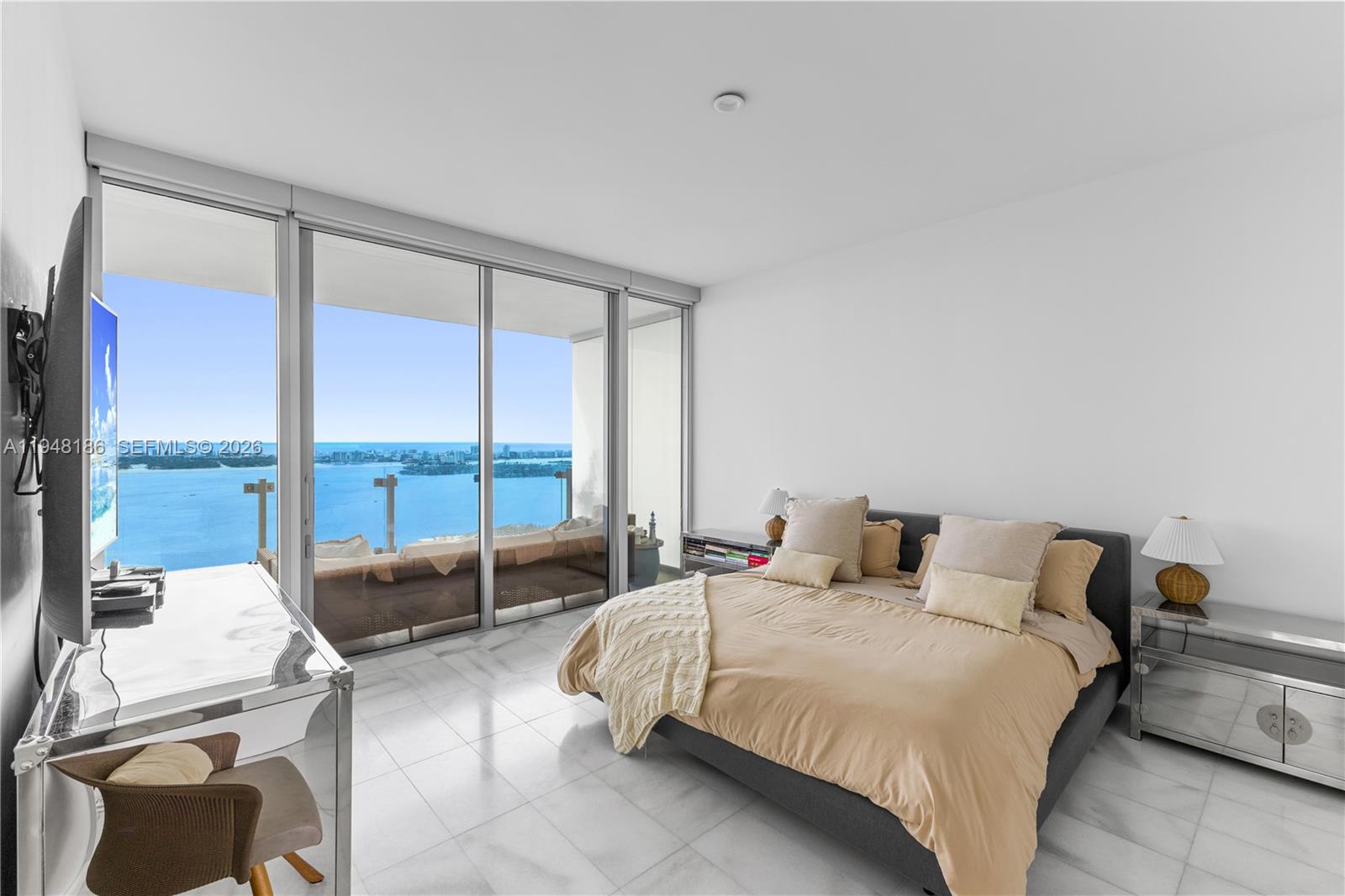 700 Northeast 26th Terrace, Unit 4701 Miami, FL 33137 - Photo 16 of 33 a bedroom with a bed and large glass window