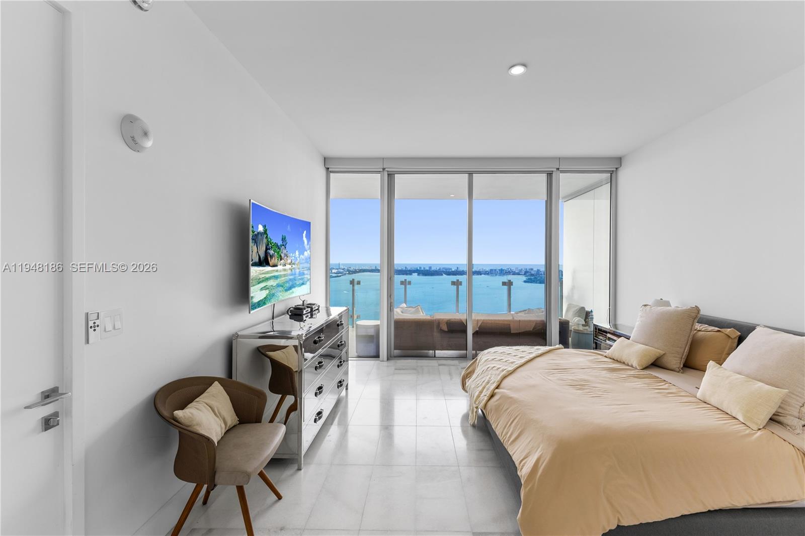 700 Northeast 26th Terrace, Unit 4701 Miami, FL 33137 - Photo 17 of 33 a bedroom with a bed and a flat screen tv