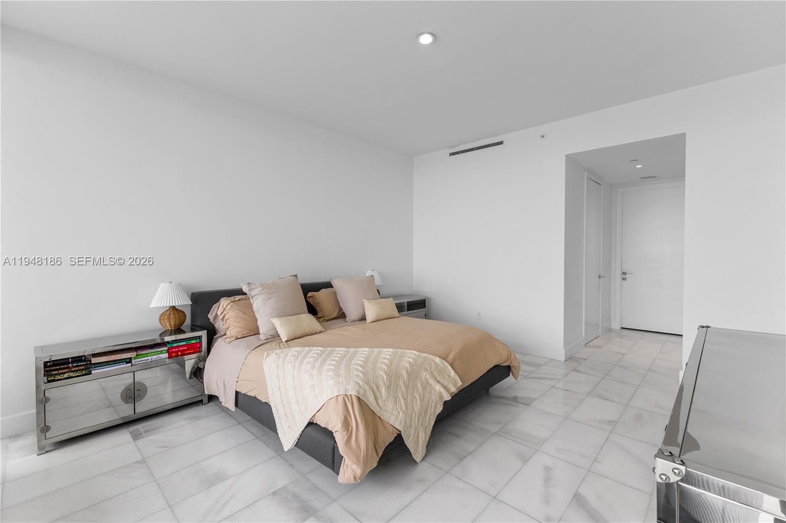 700 Northeast 26th Terrace, Unit 4701 Miami, FL 33137 - Photo 18 of 33 a bedroom with a bed and a machine