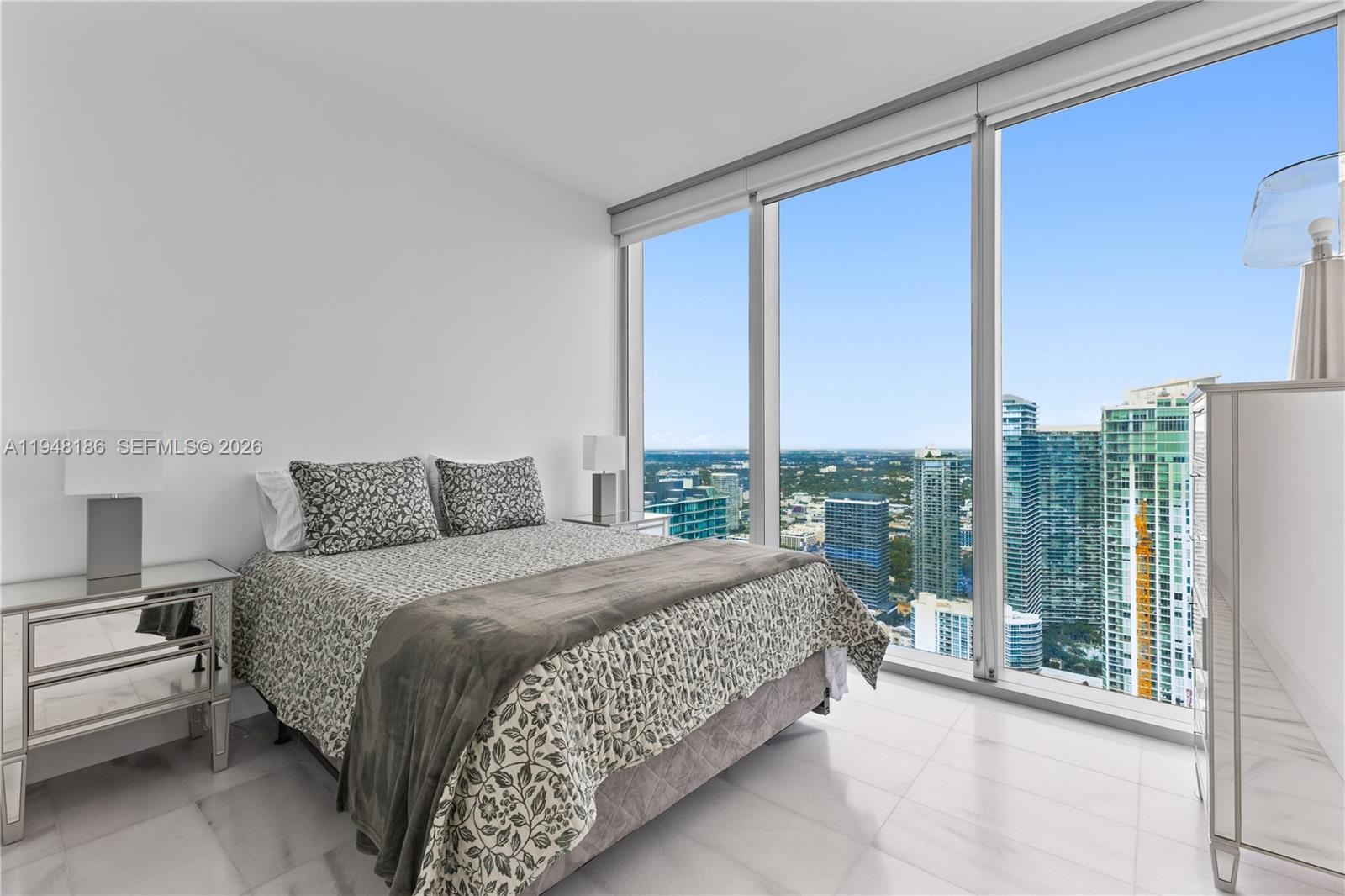 700 Northeast 26th Terrace, Unit 4701 Miami, FL 33137 - Photo 23 of 33 a bedroom with a large bed and a large window
