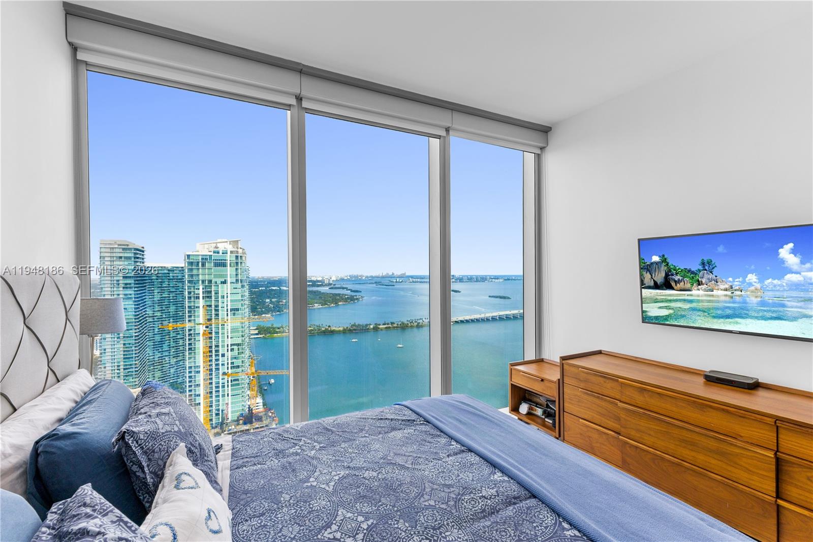 700 Northeast 26th Terrace, Unit 4701 Miami, FL 33137 - Photo 27 of 33 a bedroom with furniture and large window