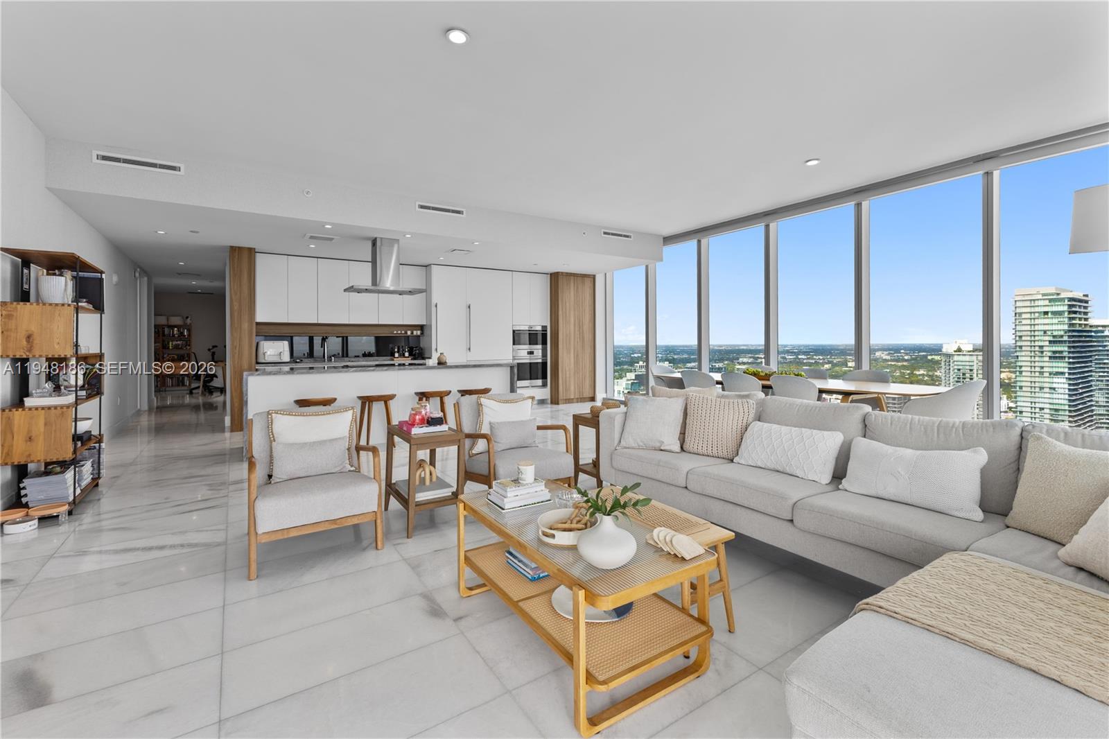 700 Northeast 26th Terrace, Unit 4701 Miami, FL 33137 - Photo 5 of 33 a living room with furniture kitchen view and large windows